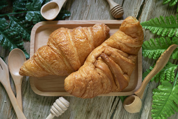 Tasty buttery croissants on  wooden table