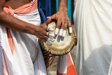 A person playing an instrument called Timila which is made of polished jackwood and held together...