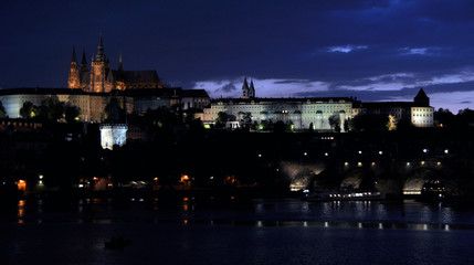 Fototapeta na wymiar Charles Bridge over the Vltava, historic quarters and St. Vitus Cathedral. Quiet summer evening in Prague.