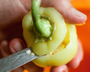 Cutting the top of the bell pepper.