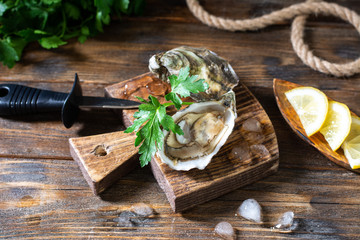 Two oysters on a wooden Board against the background of a basket of oysters	