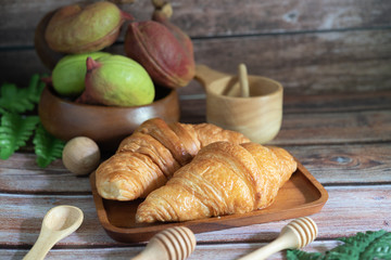 Tasty buttery croissants on  wooden table