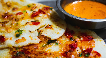 Delicious South Indian Dish Uttapam with spicy coconut chutney