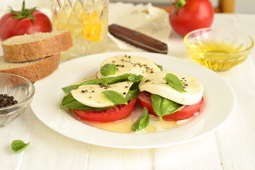 Caprese salad of tomato, mozzarella, basil. Italian food.