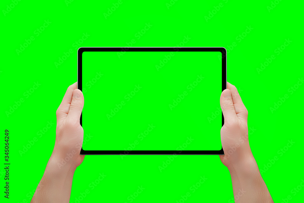 Poster tablet mockup in man hands isolated in chroma key green. front position. close-up
