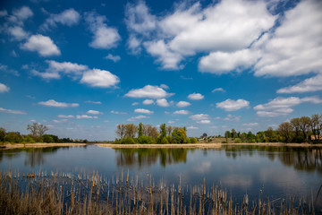 Beautiful river in the village on a sunny day with clouds. rest in the village