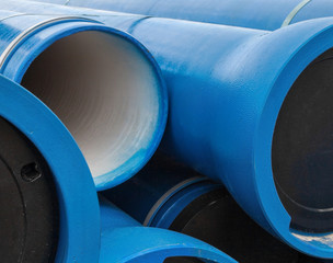 Stack of new blue pipes (tubes)