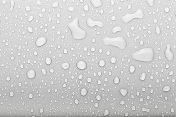 Drops of water on a color background. Selective focus. Gray