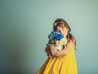 indoor studio portrait of child gril with flowers