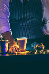 Bartender serving Baileys cream cocktail