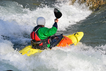 man paddling a kayak in whitewater