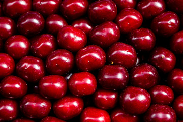 Juicy colored fruits on the counter of the farm market juicy red cherry background close up. Fruit is a source of vitamins and health. concept of strengthening immunity by nature