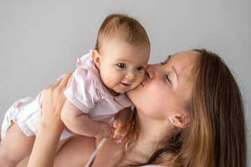 Loving mother holding her beautiful infant baby girl