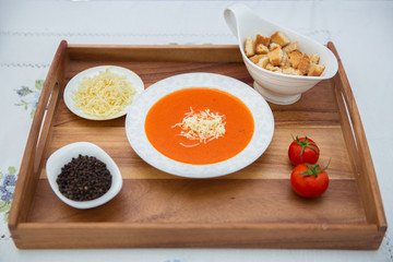 Red lentil soup . Spaghetti white plate . Dry bread and pepper . Red tomatoes . Tomato Soup wooden tray .