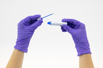 Lab tubes of biological samples contaminated by coronavirus with white blank label in doctor's hands with rubber gloves on isolated white backgroung. Healthcare, medical equipment, nasal test concept