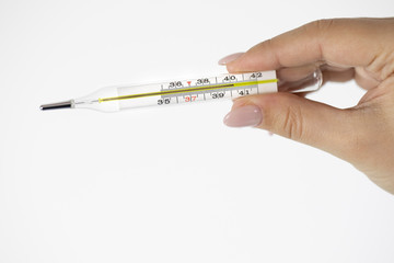 Mercury thermometer in female hand with 40,2 degrees on it isolated on white background. Abnormally high body temperature accompanied by fever, shivering, headache, delirium, disease symptoms