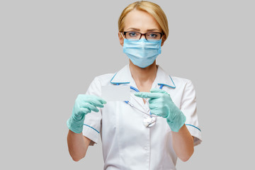 Doctor or woman nurse showing blank empty card with copy space