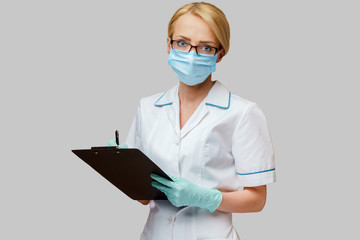 Doctor or woman nurse holding plane table and pen