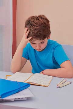 angry child doing his homework