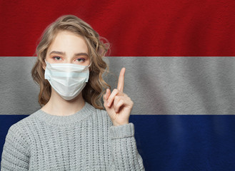 Woman in medical mask pointing up against national croatian  Flag background. Flu epidemic and...
