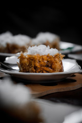 Indonesian traditional dessert with grated coconut on toping