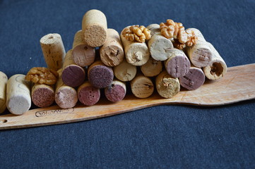 wooden spoon  corks for wine and nuts  on a black board