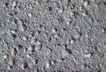 Asphalt is a dark color mixed in with the pebbles