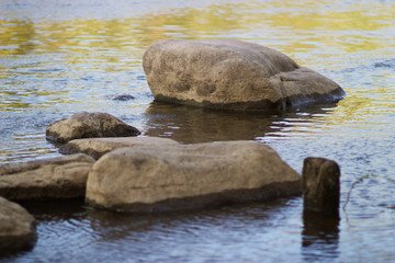 A large stone lies in the river