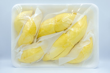 Pile of yellow durian , Close-up Thai durian placed on plastic tray. king of fruits and tropical fruit from Thailand isolated on white background, Flat lay. Top view of durian.