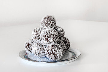 Homemade coconut / cocoa balls on Herend porcelain plate.