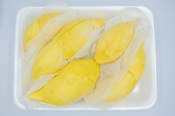 Closeup pile of  Thai durian placed on plastic tray isolated on white background