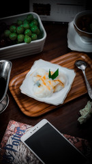 Fototapeta na wymiar Bubur sumsum, an indonesian traditional dish served on small white plate and wooden tray
