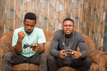 young african friends playing video games together