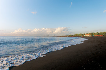 beach landscape with dark sand and clear sky