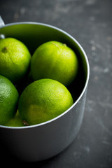 Juicy green limes on the rustic background. Selective focus. Shallow depth of field.