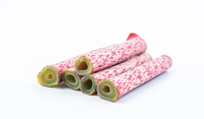 Sour tube rods with fresh wild herbs on white background