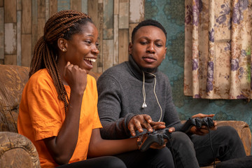 young black couple playing video game together