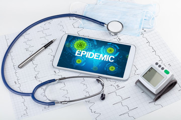 Close-up view of a tablet pc with EPIDEMIC inscription, microbiology concept