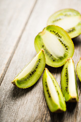 Fresh and ripe sliced kiwi on the rustic background. Selective focus. Shallow depth of field.
