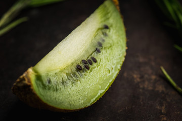 Fresh and ripe sliced kiwi on the rustic background. Selective focus. Shallow depth of field.
