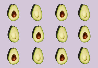 Avocado pattern isolated on purple background. Fresh. Vegetables. Food photo. 