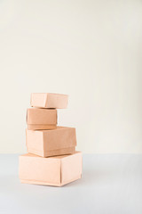 Delivery concept on a white background. Delivery of goods, food online. A lot of boxes on a white background close-up. Miniature trolley and copy space.