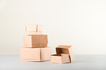 Delivery concept on a white background. Delivery of goods, food online. A lot of boxes on a white background close-up. Miniature trolley and copy space.