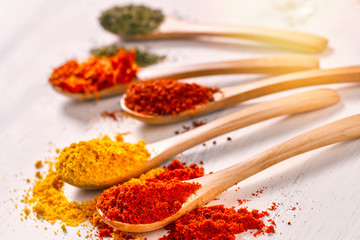 Closeup of bright spices pepper, paprika, saffron, mint