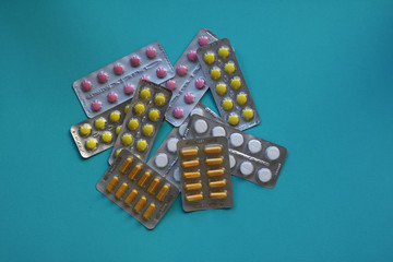 Vitamins in blister packs, close-up. Blue background