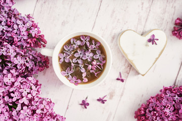 Good morning concept. Cozy morning.Happy birthday greeting card. Hello spring and summer. Greeting card for Women's Day and Mother's Day. Spring season, copy space. Cup and lilac flowers.