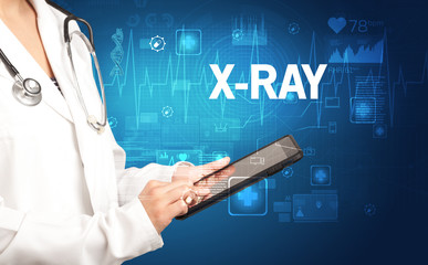 young doctor writing down notes with X-RAY inscription, healthcare concept