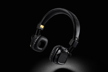 Wireless on-ear headphones on black background