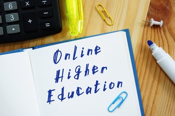 Educational concept meaning Online Higher Education with sign on the piece of paper.