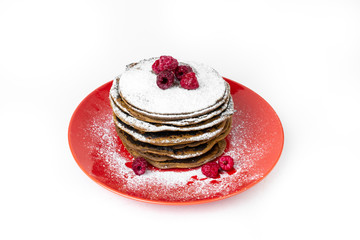 Stack of pancakes on a red plate, isolated on a white background